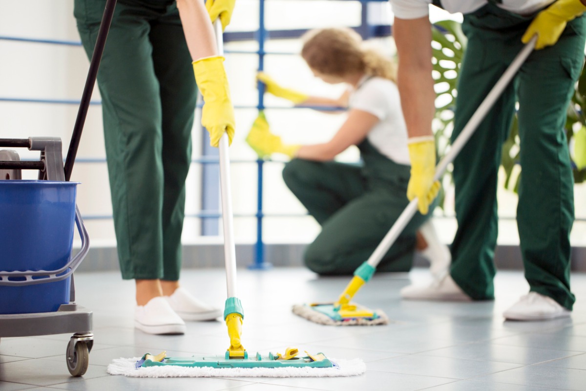 moping-floor-and-cleaning-railing-picture-id944633842